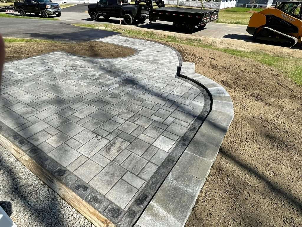 Curved granite curb and paver entrance apron under construction in Berwick, ME